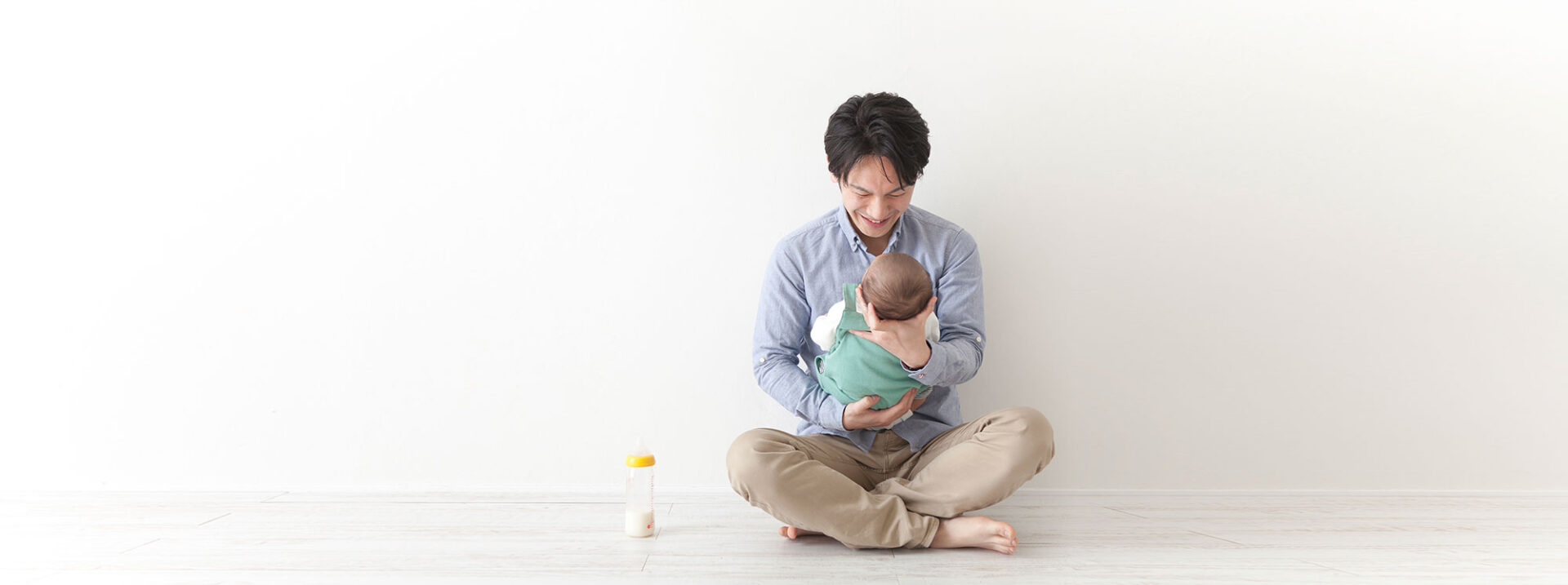 Japanese man cradling a baby
